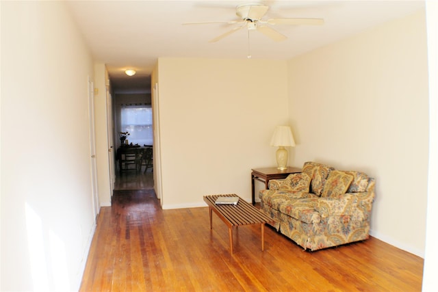 living area with hardwood / wood-style flooring and ceiling fan