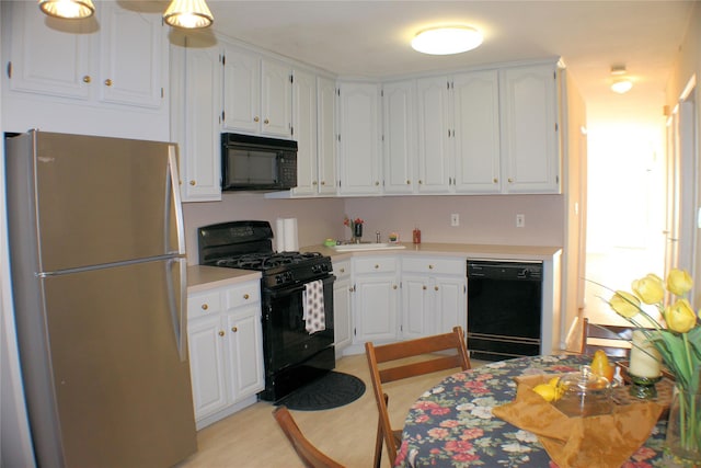 kitchen featuring white cabinets, sink, and black appliances