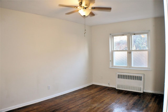 unfurnished room featuring radiator heating unit, dark hardwood / wood-style floors, and ceiling fan