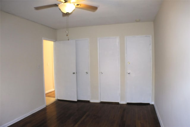 unfurnished bedroom with ceiling fan and dark hardwood / wood-style flooring