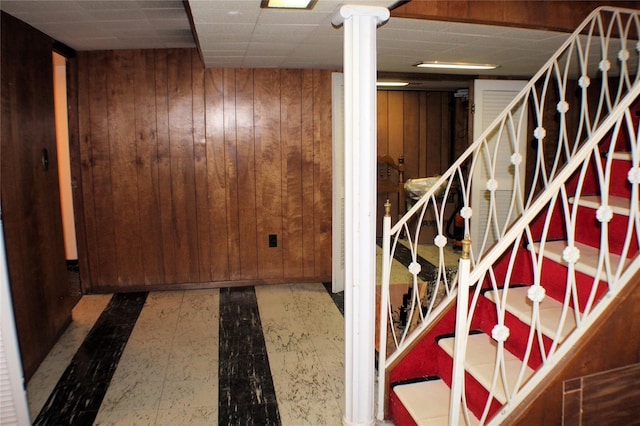 basement featuring wooden walls