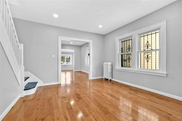 interior space with a healthy amount of sunlight, light wood-type flooring, and radiator