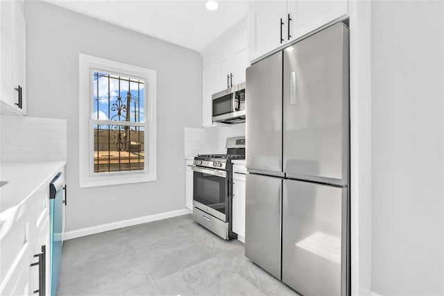 kitchen featuring appliances with stainless steel finishes, tasteful backsplash, and white cabinetry