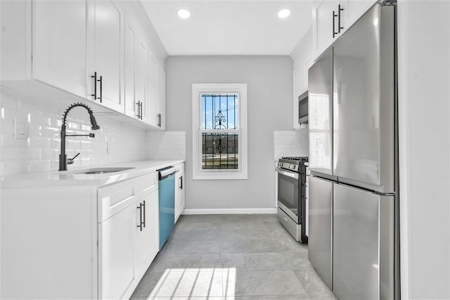 kitchen featuring decorative backsplash, sink, white cabinetry, and stainless steel appliances