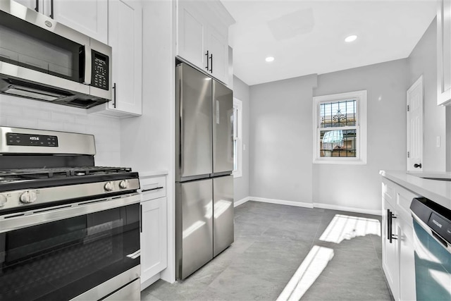 kitchen with white cabinets and appliances with stainless steel finishes