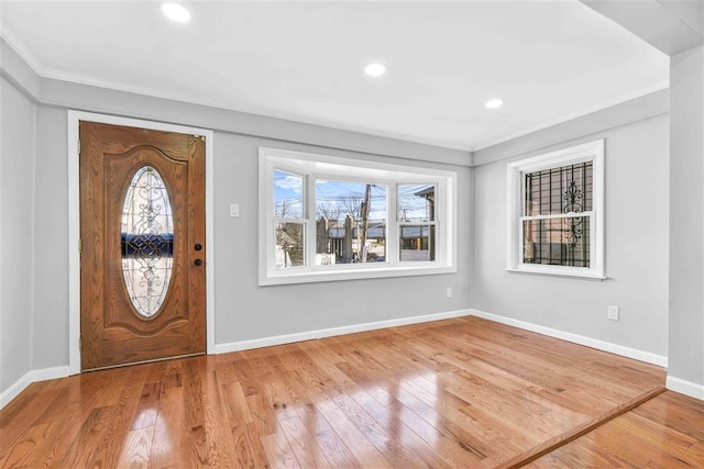 entrance foyer with light wood-type flooring and crown molding