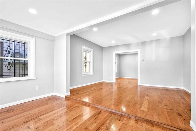 unfurnished room with hardwood / wood-style flooring