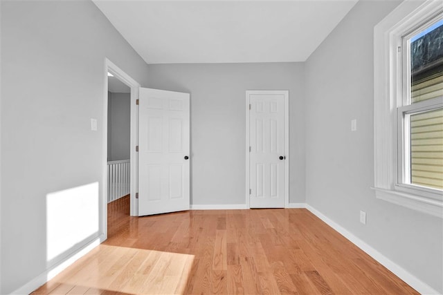 unfurnished bedroom with light wood-type flooring