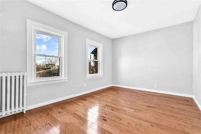 empty room featuring light hardwood / wood-style flooring and radiator