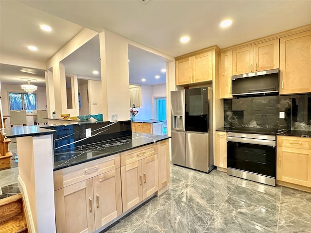 kitchen with light brown cabinetry, decorative backsplash, stainless steel appliances, and kitchen peninsula