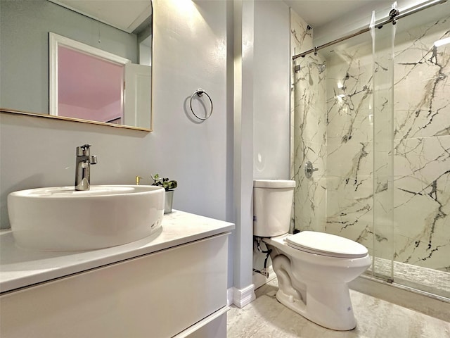 bathroom with toilet, a tile shower, and vanity