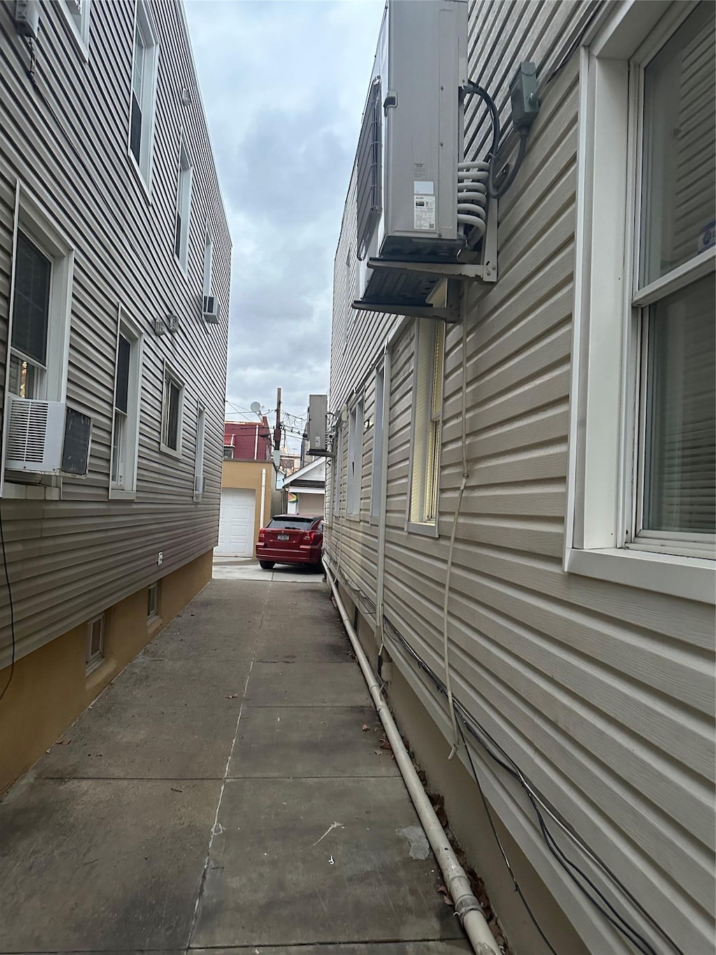 view of home's exterior featuring cooling unit and a garage