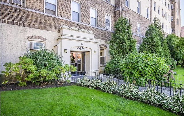 doorway to property with a yard