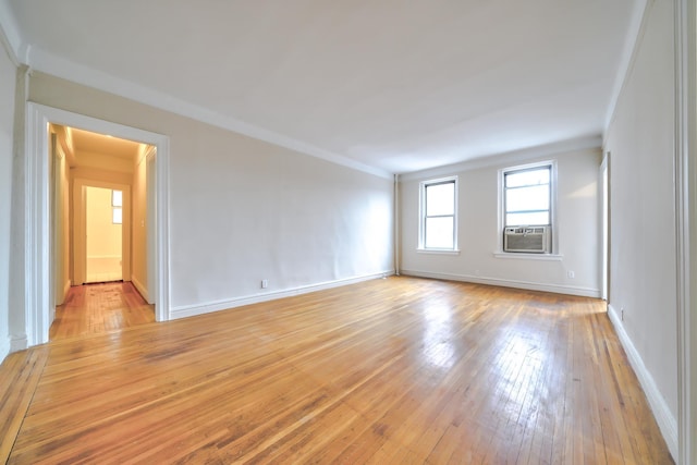 spare room featuring crown molding, cooling unit, and light hardwood / wood-style floors