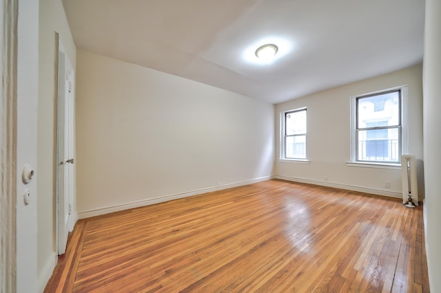 spare room featuring light hardwood / wood-style floors and radiator