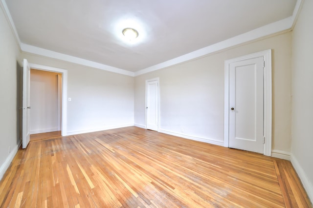 unfurnished room with light hardwood / wood-style floors and ornamental molding