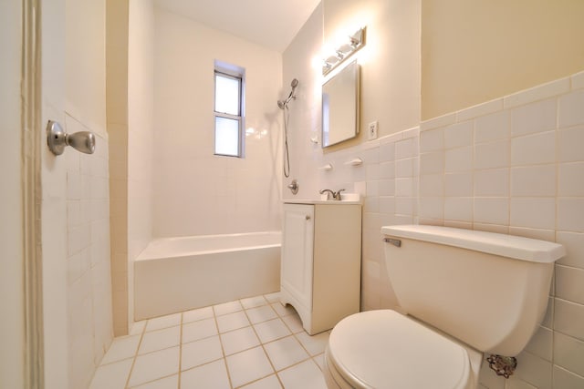 full bathroom featuring tile patterned floors, vanity, tile walls, toilet, and tiled shower / bath