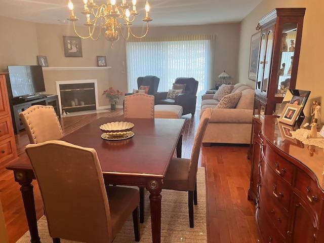 dining area with a chandelier and wood-type flooring