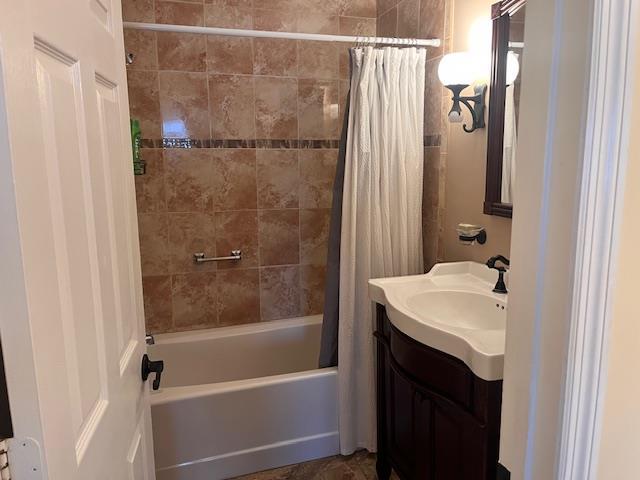 bathroom with shower / bathtub combination with curtain and vanity