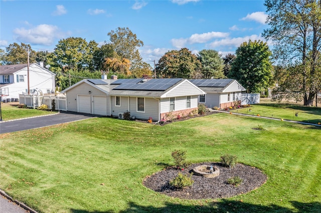 ranch-style home with a front lawn and a garage