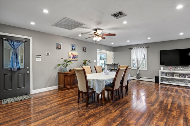 dining area featuring baseboard heating, dark hardwood / wood-style floors, and ceiling fan