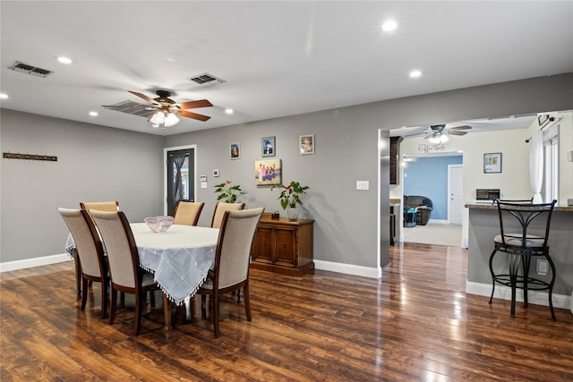 dining area with ceiling fan and dark hardwood / wood-style floors