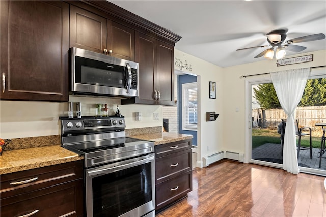 kitchen with light stone countertops, dark hardwood / wood-style floors, appliances with stainless steel finishes, and dark brown cabinetry