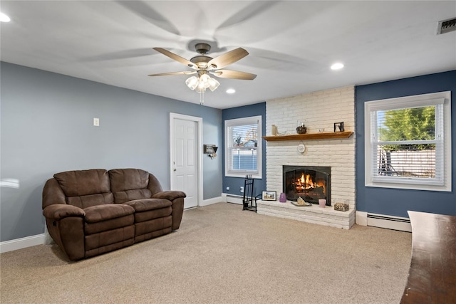 carpeted living room with baseboard heating, a brick fireplace, and ceiling fan