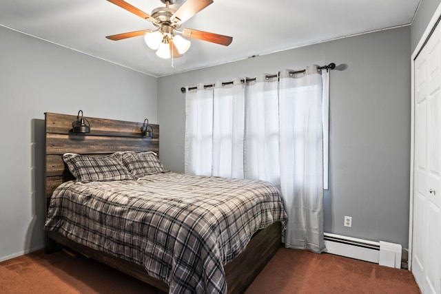 carpeted bedroom with ceiling fan, a baseboard heating unit, and a closet