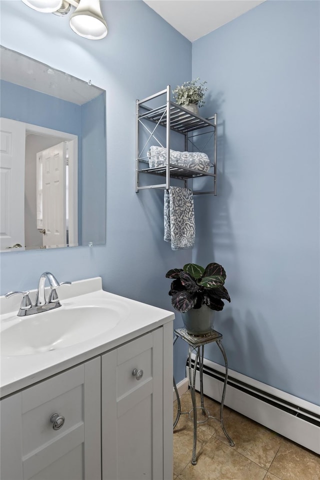 bathroom with a baseboard radiator, tile patterned floors, and vanity