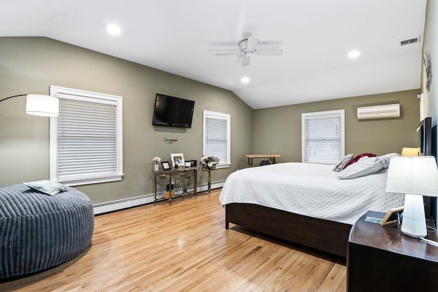 bedroom with ceiling fan, vaulted ceiling, a wall unit AC, light wood-type flooring, and a baseboard radiator