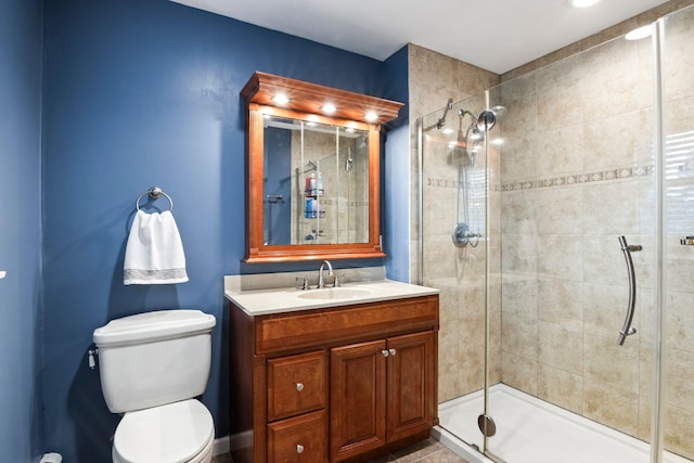 bathroom featuring toilet, walk in shower, and vanity