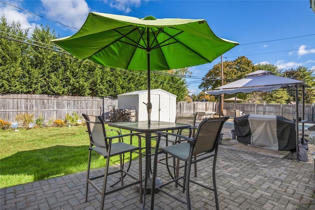 view of patio featuring a grill and a storage shed