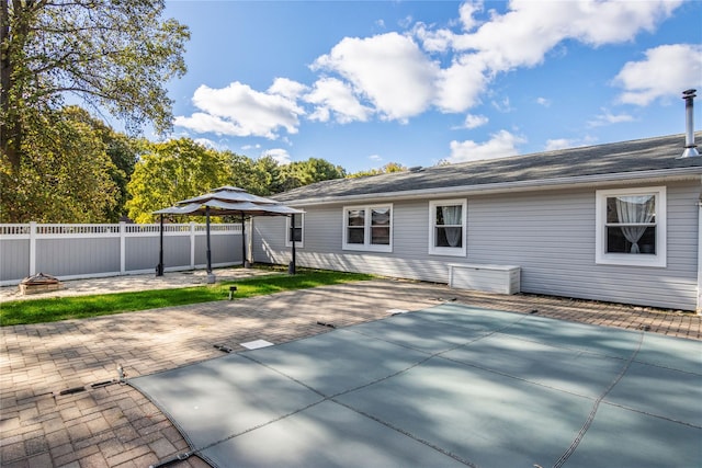 rear view of property with a gazebo and a patio