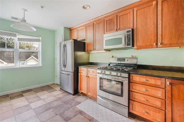 kitchen with appliances with stainless steel finishes and pendant lighting