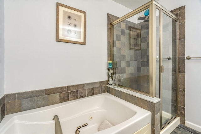 bathroom featuring separate shower and tub