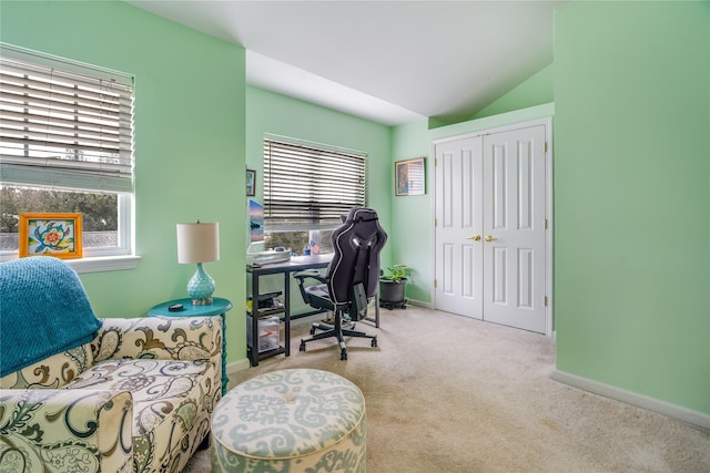 carpeted office space with vaulted ceiling