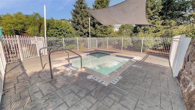 view of pool with a patio area and an in ground hot tub