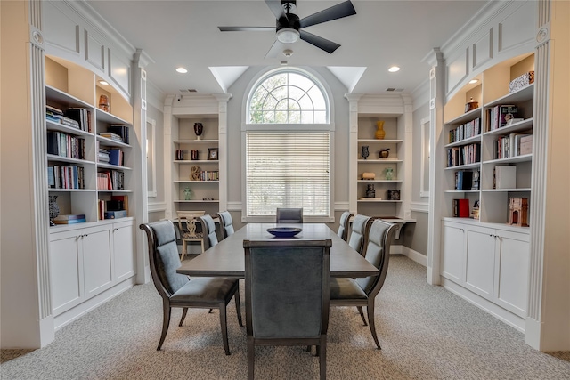 carpeted dining area with ceiling fan and built in features