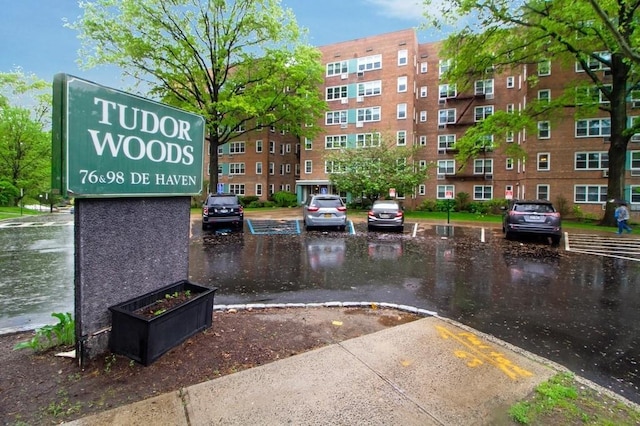 view of property's community with uncovered parking and a water view