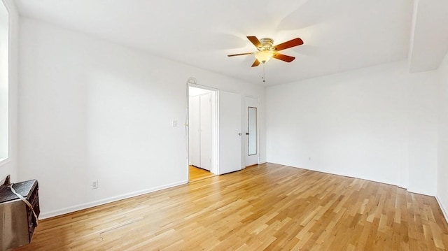 spare room featuring light wood finished floors and ceiling fan