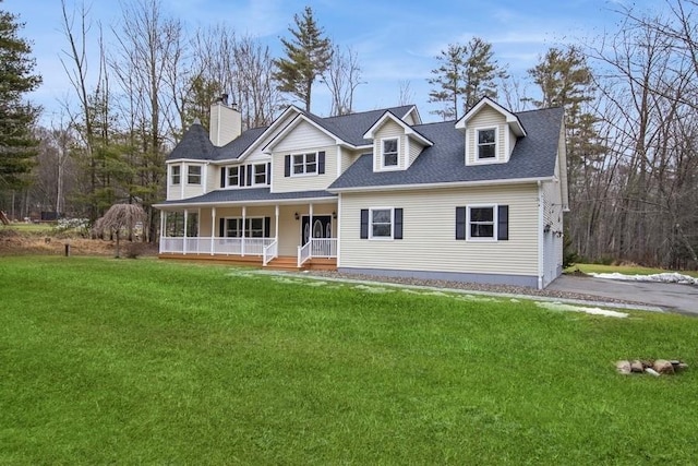 view of front of property with covered porch and a front lawn