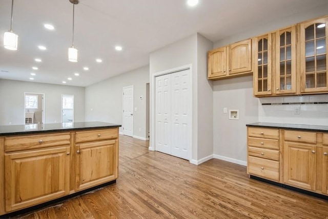 kitchen featuring decorative light fixtures, wood-type flooring, and backsplash