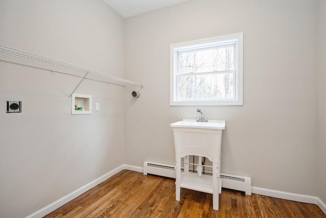 laundry area featuring hookup for an electric dryer, hardwood / wood-style flooring, hookup for a washing machine, and a baseboard radiator