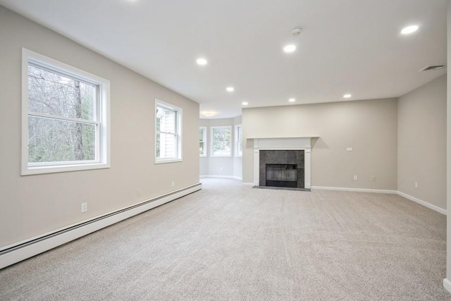 unfurnished living room with a tiled fireplace, light carpet, and a baseboard radiator