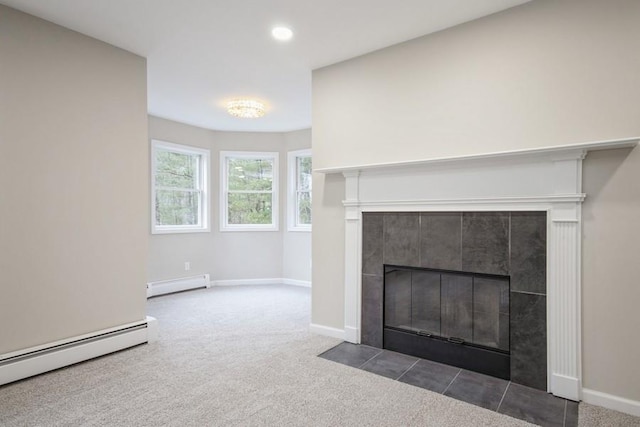 interior details featuring carpet floors, a baseboard radiator, and a tiled fireplace