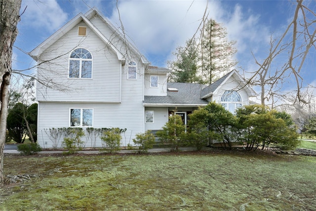 back of house featuring a yard