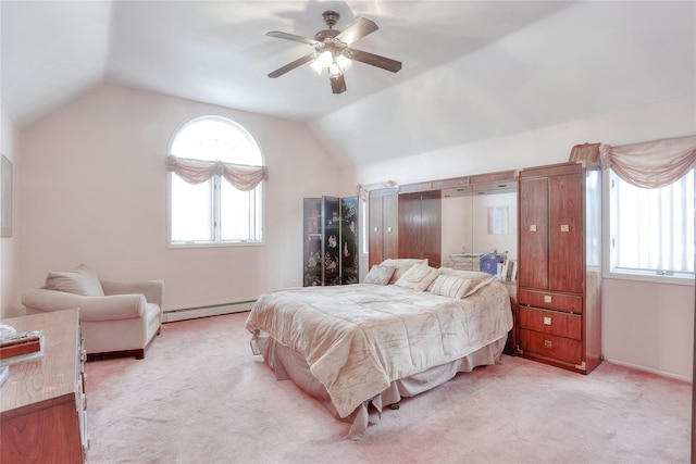 bedroom featuring light colored carpet, vaulted ceiling, ceiling fan, and a baseboard heating unit