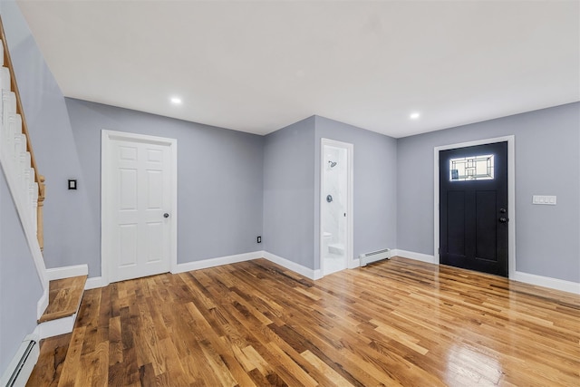 foyer entrance with hardwood / wood-style floors and a baseboard radiator