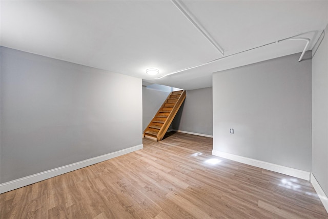 basement with light hardwood / wood-style flooring